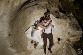 Turkey bride and groom to be, relaxing for a Cappadocia pre-wedding engagement session lying down on the rocks