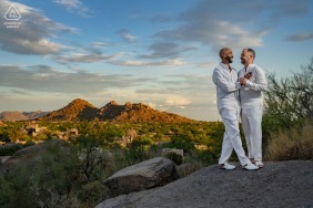 A couple poses together in front of the beautiful backdrop of the Boulders Resort & Spa during their engagement session in Scottsdale, AZ
