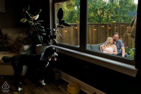 At the couple's home in Kansas City, Missouri, they sit on a bench outdoors on the patio, captured through the window with their dog looking on lovingly.