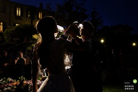 The Newlyweds drink from the goblets after cutting the cake at Villa Bossi, Varese - ITALY